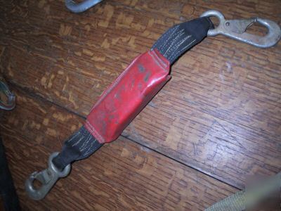 Shock absorbing lanyard for fall arrest safety harness